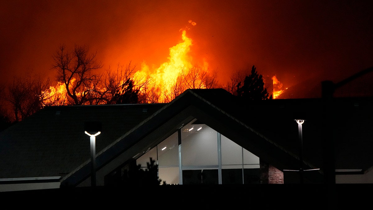 Flames explode as wildfires burned near a small shopping center Thursday, Dec. 30, 2021, near Broomfield, Colorado. Homes surrounding the Flatiron Crossing mall were being evacuated as wildfires raced through the grasslands as high winds raked the intermountain West.