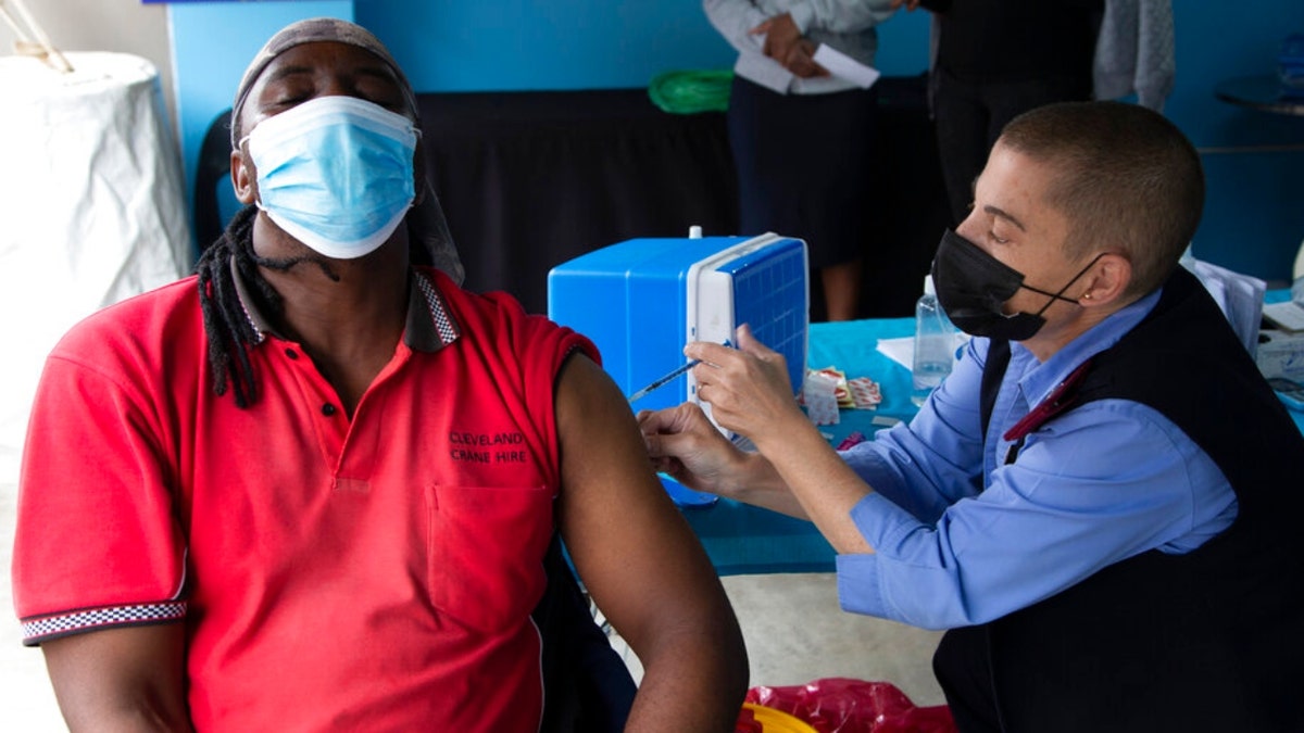 A man gets vaccinated against COVID-19 at a site near Johannesburg, Monday, Dec. 13, 2021, a day after South African President Cyril Ramaphosa tested positive receiving for mild COVID-19 symptoms after testing positive for the disease.  