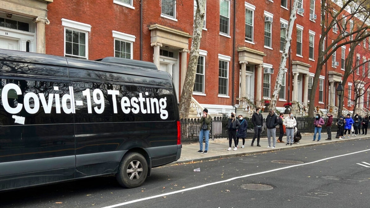 A line stretches down the block as people wait in line to be tested for COVID-19 in New York on Thursday, Dec. 16, 2021.  