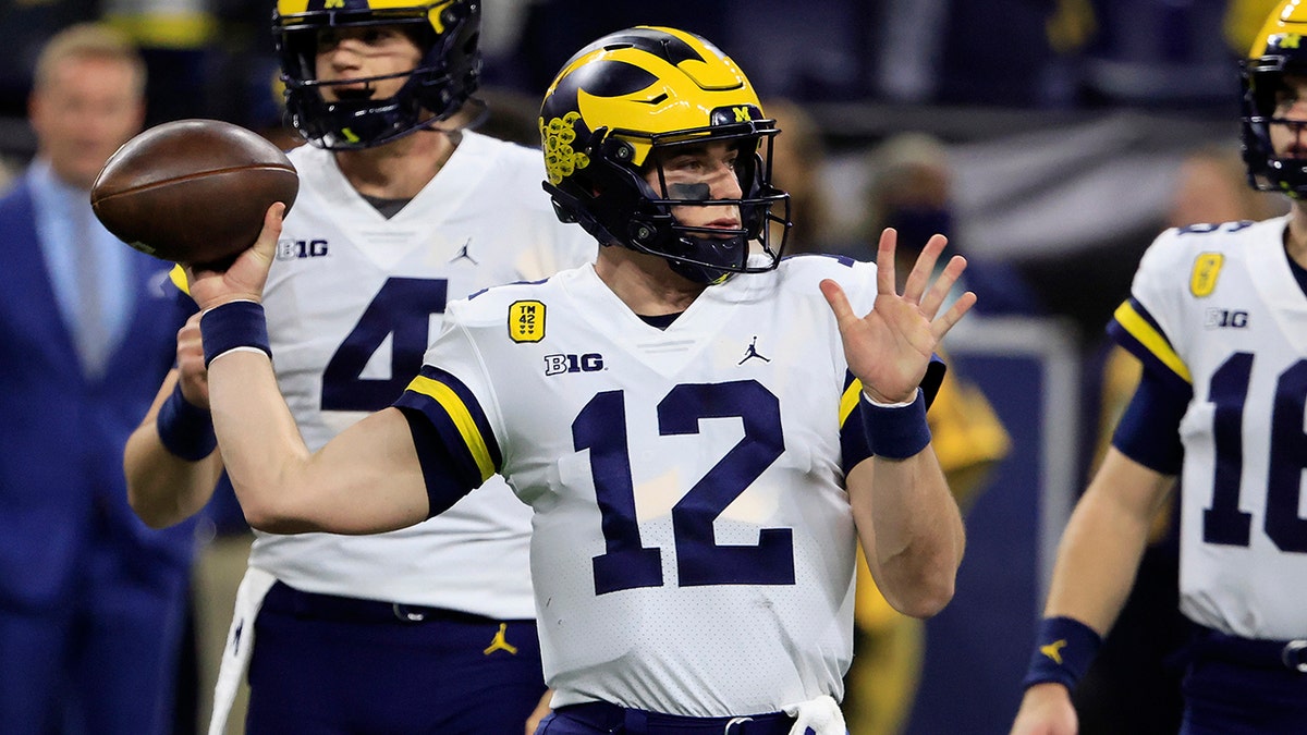 INDIANAPOLIS, INDIANA - DECEMBER 04: Cade McNamara #12 of the Michigan Wolverines warms up before the Big Ten Football Championship game against the Iowa Hawkeyes at Lucas Oil Stadium on December 04, 2021 in Indianapolis, Indiana.