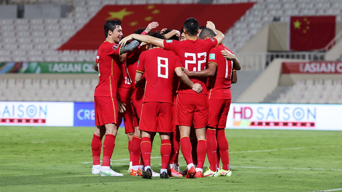 Members of China PR celebrate scoring their first goal during the FIFA World Cup Asian Qualifier final round Group B match between China and Vietnam at Sharjah Stadium on Oct. 7, 2021, in Sharjah, United Arab Emirates.