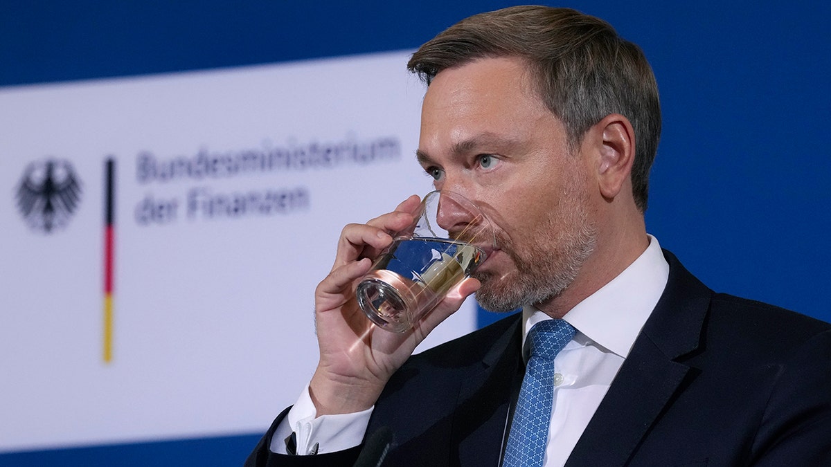 German Finance Minister Christian Lindner drinks water before he addresses the media during a press conference after a meeting of the stability council in Berlin, Germany, Friday, Dec. 10, 2021. 