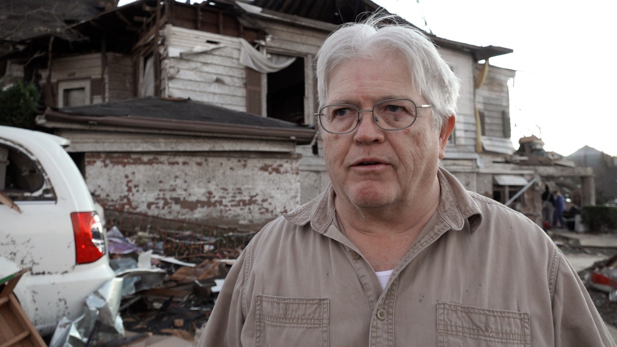 Mayfield, Kentucky resident Tommy Anderson stands in front of his home