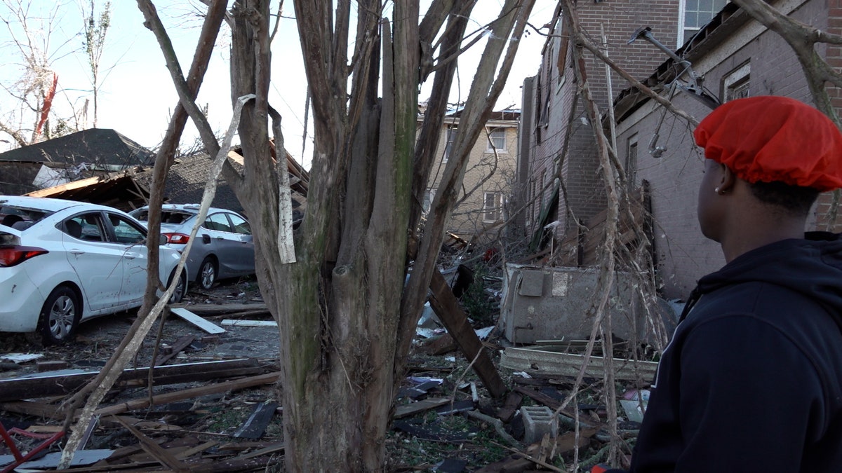 Mayfield, Kentucky resident Ja-sean Kocatow looks at tornado damage