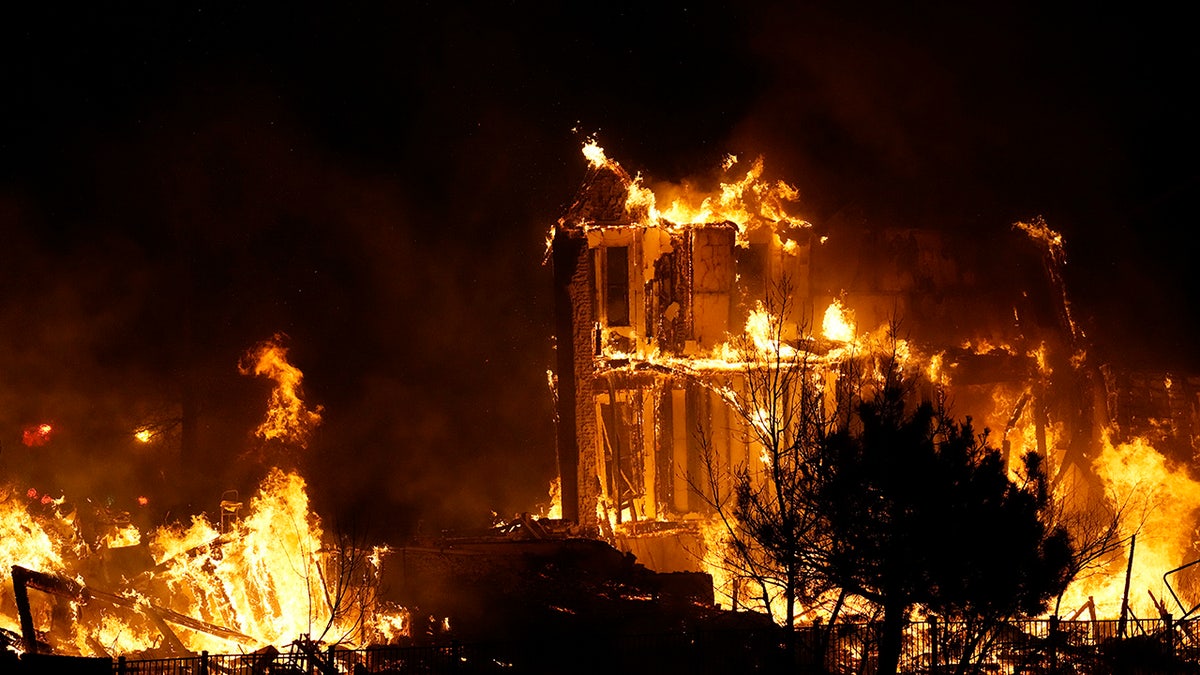 Homes burn as a wildfire rips through a development near Rock Creek Village, near Broomfield, Colorado.