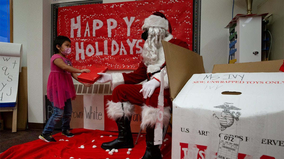 Marines from the 4th Law Enforcement Battalion distribute toys to children in remote villages in support of the Toys for Tots program in Alaska.