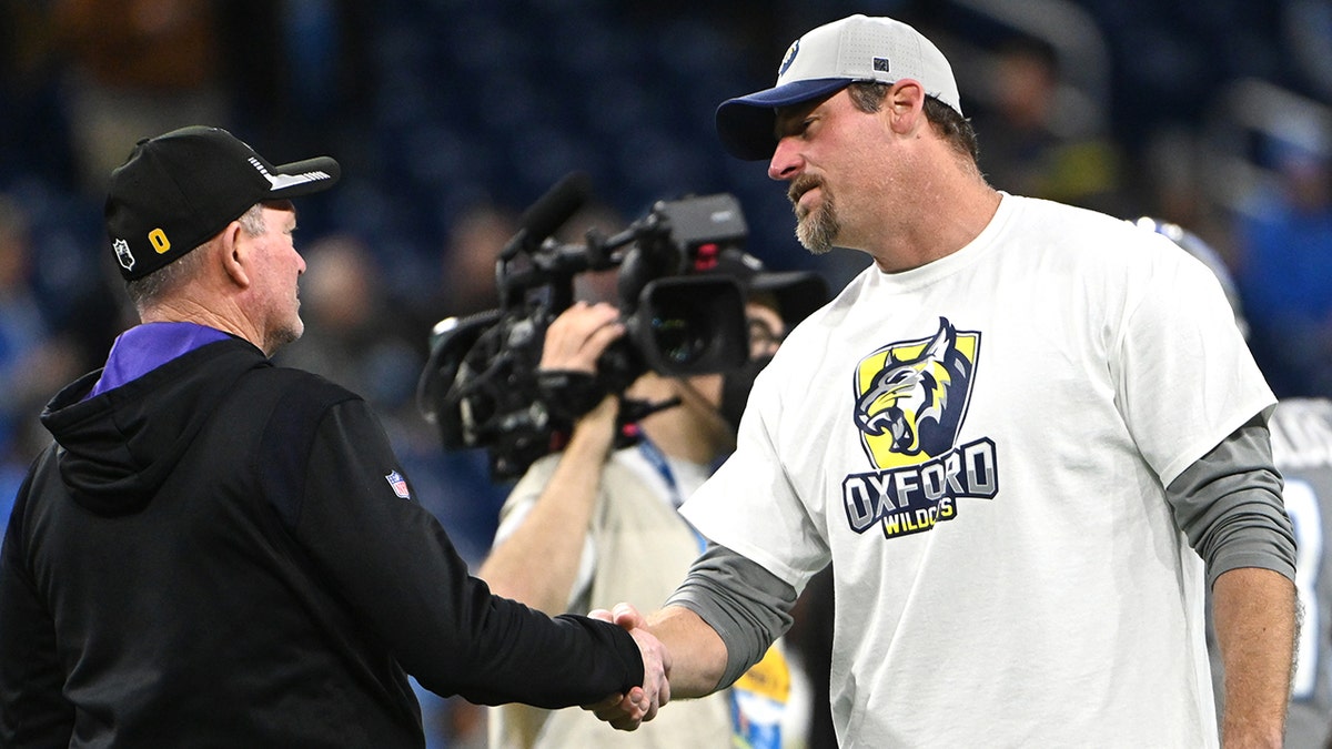 DETROIT, MICHIGAN - DECEMBER 05: (L-R) Head coach Mike Zimmer of the Minnesota Vikings shakes hands with head coach Dan Campbell of the Detroit Lions before the game at Ford Field on December 05, 2021 in Detroit, Michigan.