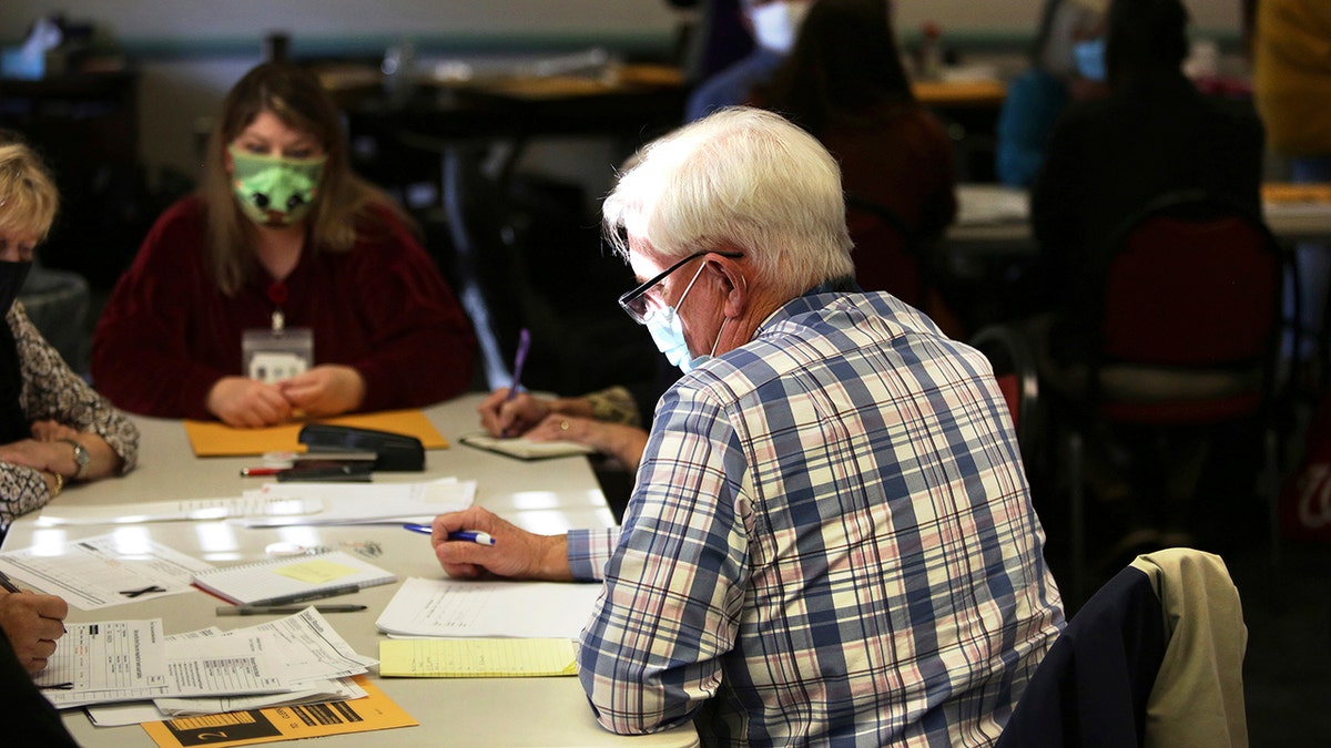 Election officials begin the process of recounting one of two unresolved races that will settle whether Virginia Republicans have reclaimed the majority in the House of Delegates, Thursday, Dec. 2, 2021 in Virginia Beach, Virginia.