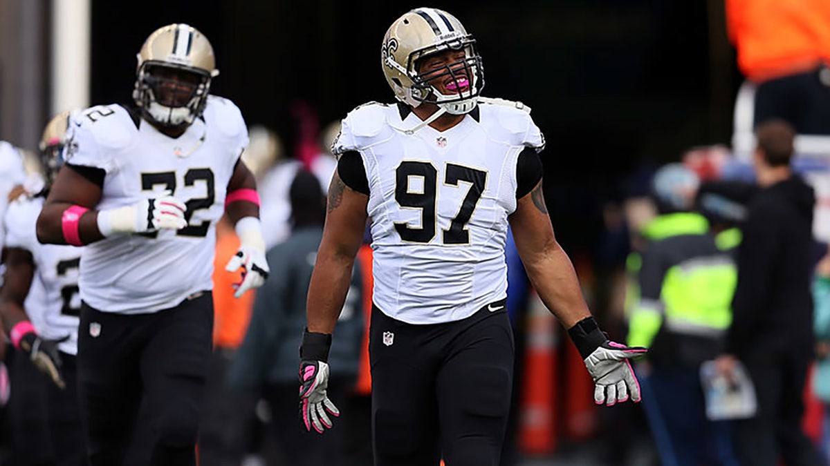 Glenn Foster takes the field before a game against the Patriots