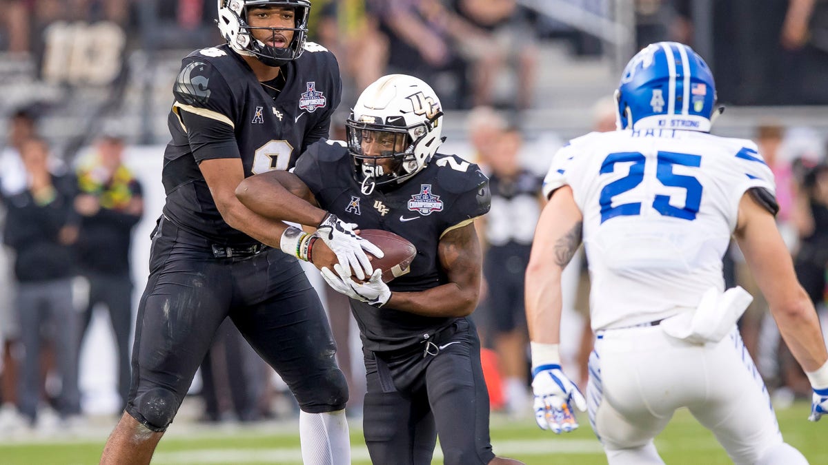 ORLANDO, FL - DECEMBER 01: UCF Knights quarterback Darriel Mack Jr. (8) hands off to UCF Knights running back Otis Anderson (2) during the AAC Championship football game between the UCF Knights and the Memphis Tigers on December 1, 2018 at Bright House Networks Stadium in Orlando, FL. 