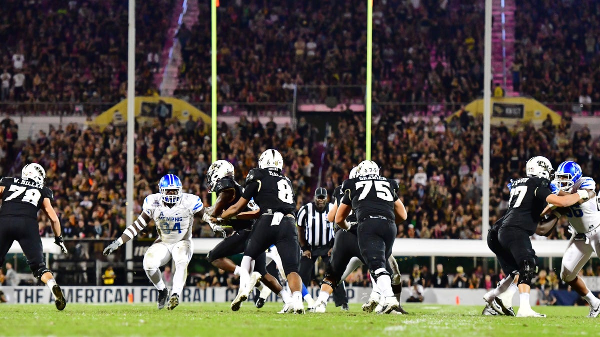 ORLANDO, FLORIDA - DECEMBER 01: Darriel Mack Jr. #8 of the UCF Knights hands the ball off to Otis Anderson #2 during the third quarter of the American Athletic Championship against the Memphis Tigers at Spectrum Stadium on December 01, 2018 in Orlando, Florida. 