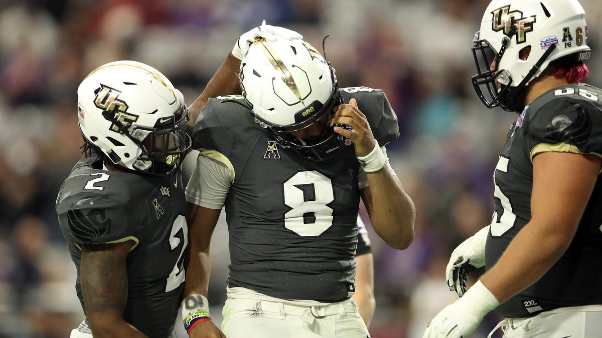 GLENDALE, ARIZONA - JANUARY 01: Running back Otis Anderson #2 hugs teammate quarterback Darriel Mack Jr. #8 of the UCF Knights during the fourth quarter of the PlayStation Fiesta Bowl between LSU and Central Florida at State Farm Stadium on January 01, 2019 in Glendale, Arizona. 