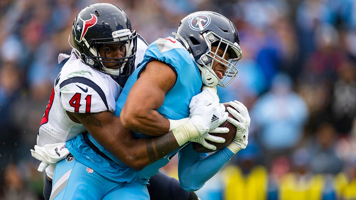 Zach Cunningham (41) of the Houston Texans tackles Khari Blasingame of the Tennessee Titans short of the goal line during the third quarter at Nissan Stadium on Dec. 15, 2019 in Nashville, Tenn.