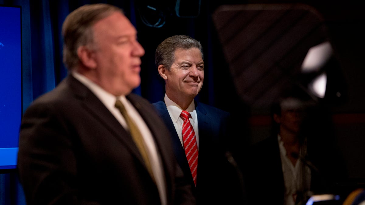 Secretary of State Mike Pompeo, accompanied by Sam Brownback, ambassador at large for international religious freedom, speaks during a news conference at the State Department in Washington, D.C., on June 10, 2020. (