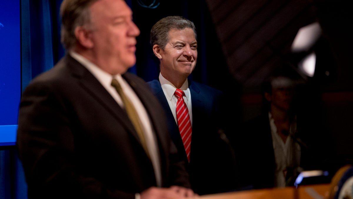 Secretary of State Mike Pompeo, accompanied by Sam Brownback, ambassador at large for international religious freedom, speaks during a news conference at the State Department in Washington, D.C., on June 10, 2020. (