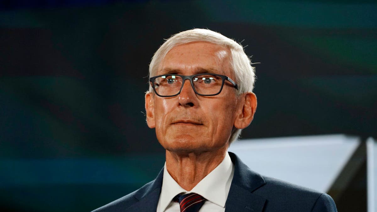 Tony Evers wearing glasses and a suit