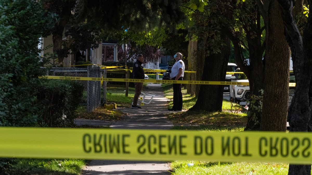 ROCHESTER, NY - SEPTEMBER 19: Police officers investigate a crime scene after a shooting at a backyard party on September 19, 2020, Rochester, New York. Two young adults - a man and a woman - were reportedly killed, and 14 people were injured in the shooting early on Saturday morning on the 200th block of Pennsylvania Avenue, located in the city's Marketview Heights neighborhood. Police say several dozen shots were fired. (Photo by Joshua Rashaad McFadden/Getty Images)