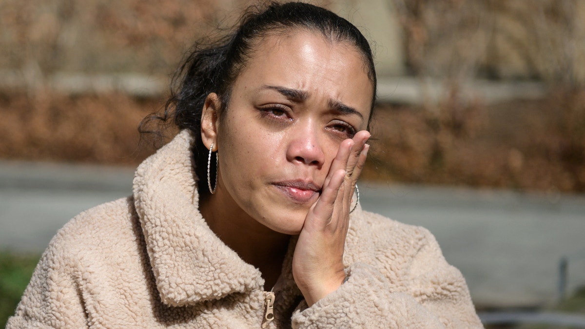 Elizabeth Medina, a 38-year-old school guidance counselor, wipes tears from her cheek during an interview with AFP outside NewYork-Presbyterian Hospital on March 22, 2021 in New York City. - Three days after testing positive for Covid-19, "everything tasted like cardboard," recalls 38-year-old Elizabeth Medina, who lost her sense of taste and smell at the start of the pandemic. A year later, she fears she will never get them back. Medina consulted ear, nose and throat doctors and neurologists, tried various nasal sprays, and is part of a group of patients undergoing experimental treatment that uses fish oil. (Photo by Angela Weiss / AFP) (Photo by ANGELA WEISS/AFP via Getty Images)