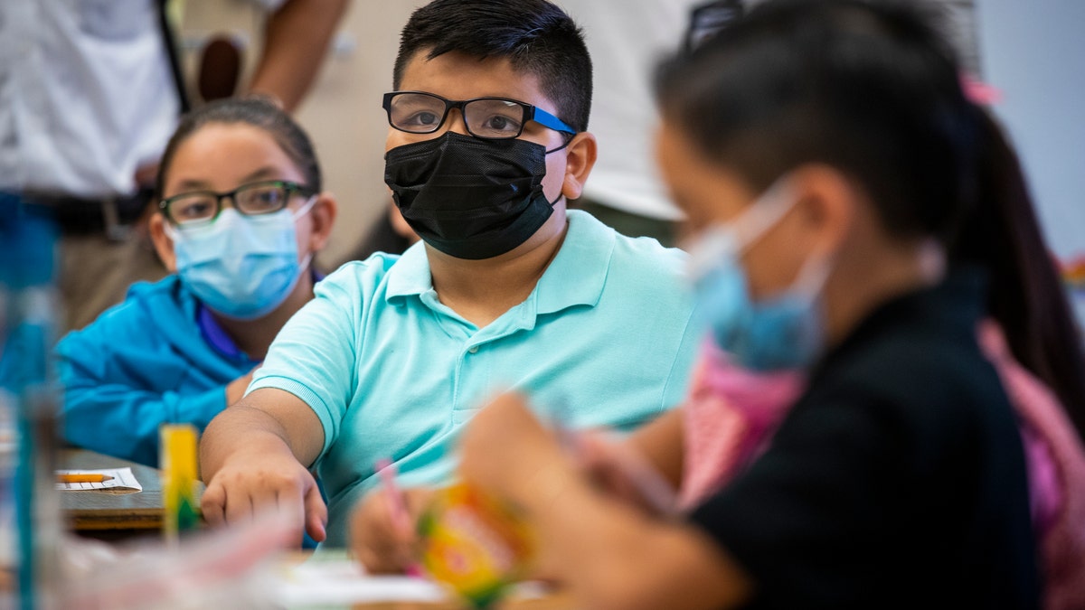 Elementary students in classroom wear masks in Los Angeles, California