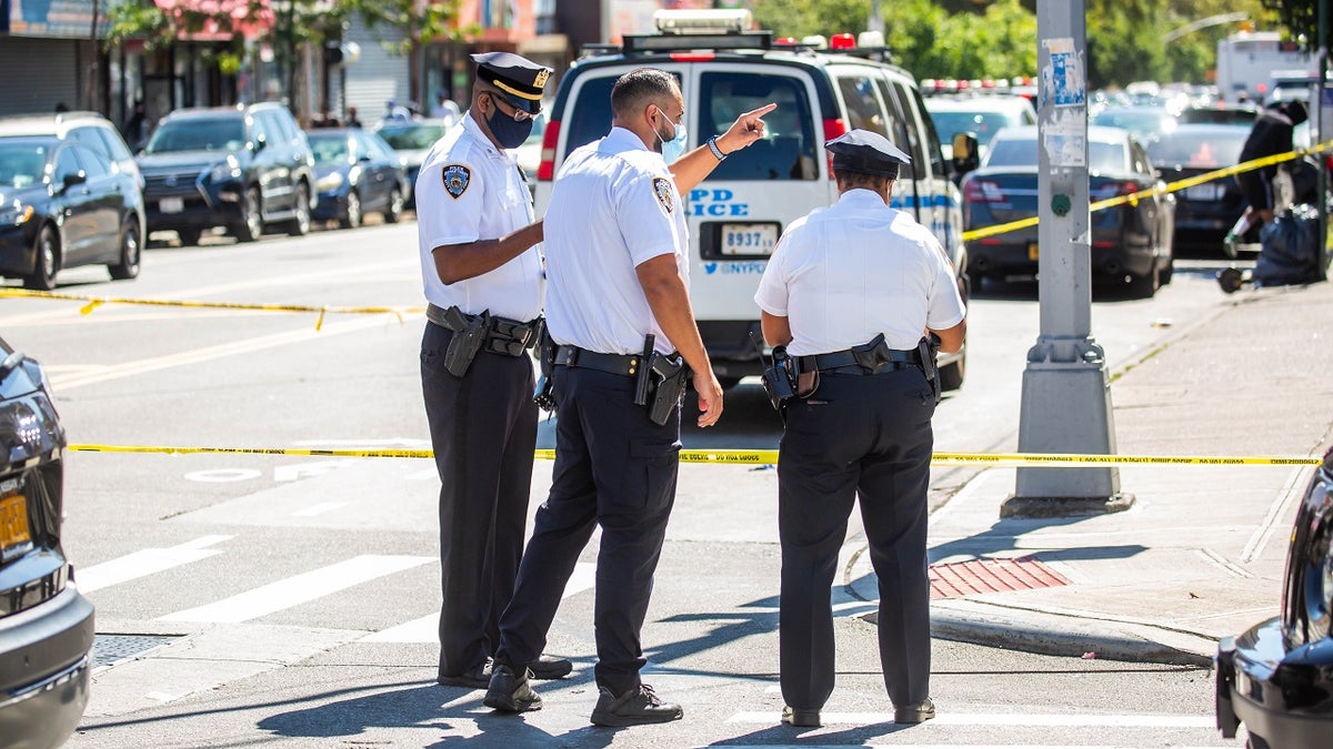NYPD officers monitor a crime scene in the 73th precinct in the Brownsville neighborhood of Brooklyn borough Sept. 19, 2021. 