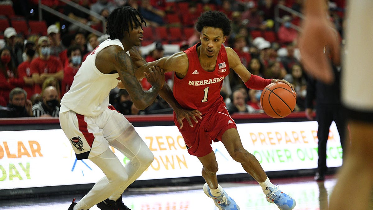 Nebraska Cornhuskers guard Alonzo Verge Jr. (1) drives on North Carolina State Wolfpack guard Dereon Seabron (1) during the game between the North Carolina State Wolfpack and the Nebraska Cornhuskers at PNC Arena on December 1, 2021 in Raleigh, NC.