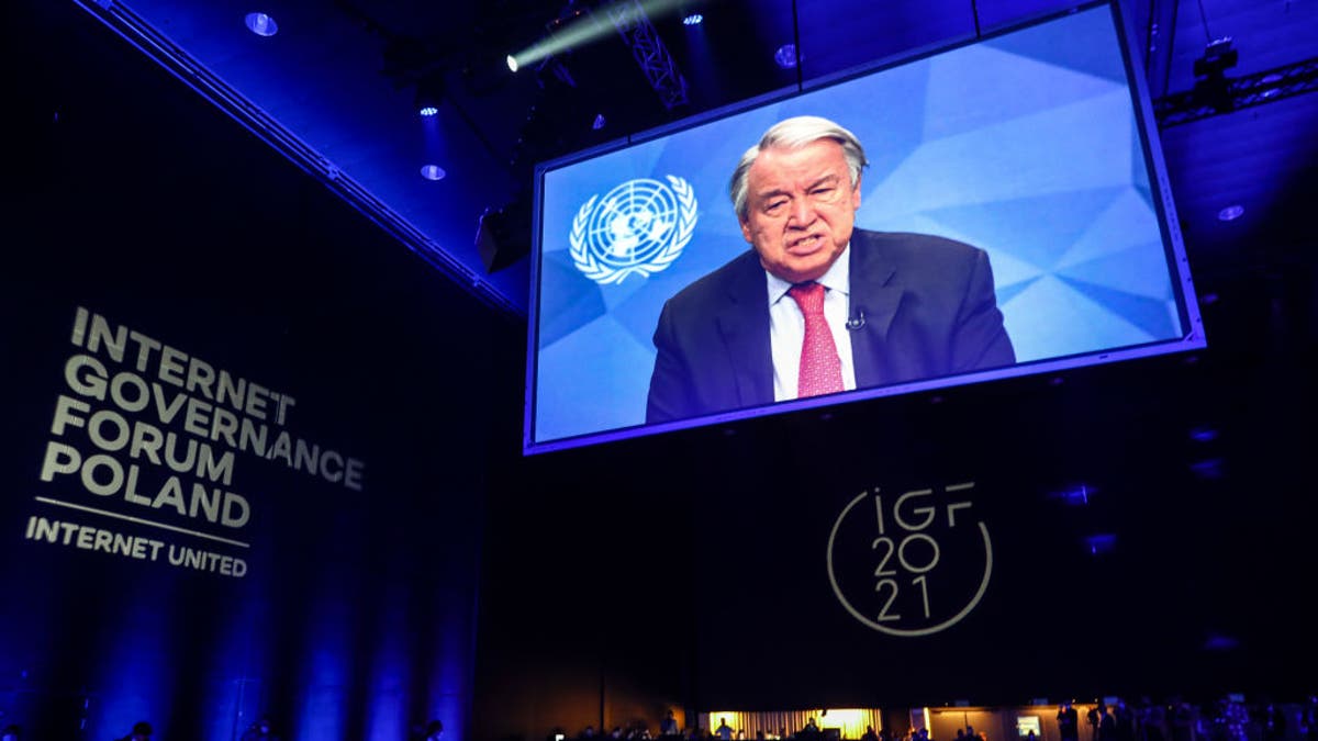 United Nations Secretary-General Antonio Guterres is shown on the screen while speaking at the opening ceremony of the UN Internet Governance Forum in Katowice, Poland on Dec. 7, 2021. 