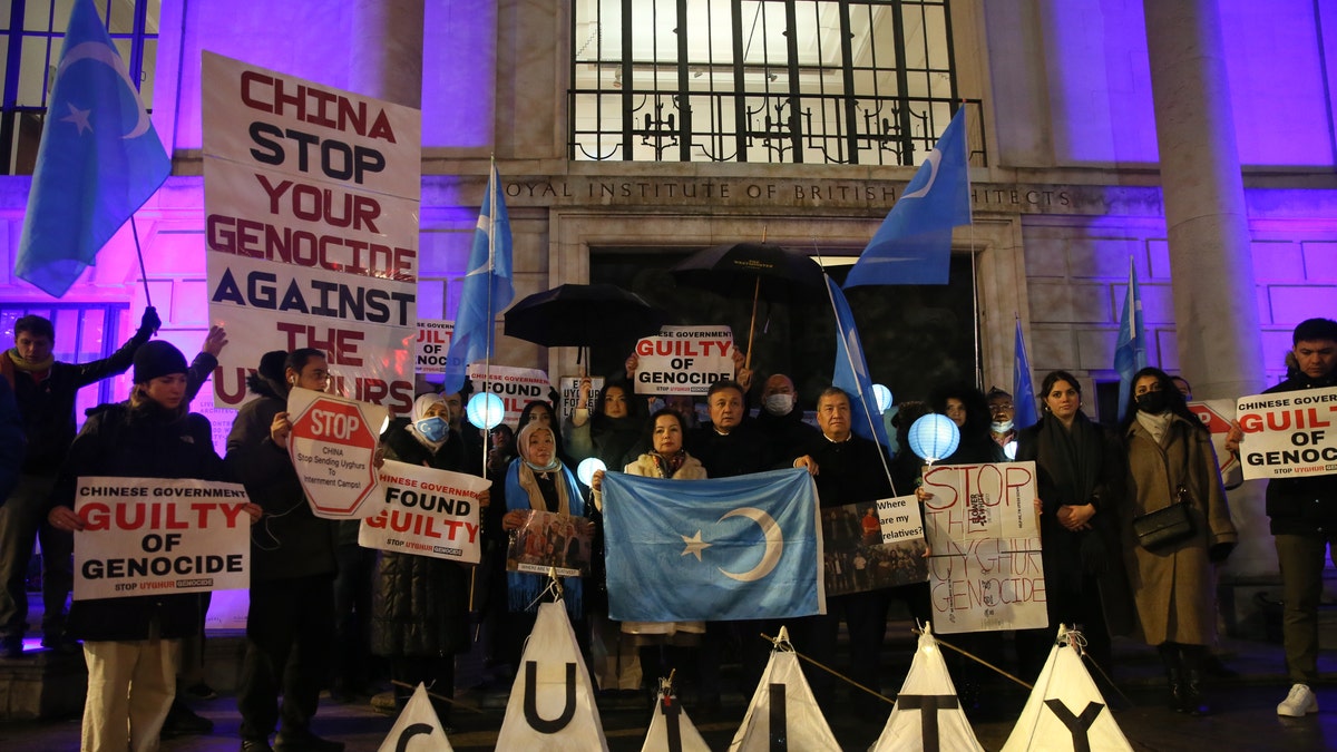 People stage a protest in front of the Chinese Embassy after the Uyghur Tribunal ruled that China committed genocide against Uyghurs and other ethnic minorities through policies such as coerced birth control and sterilization in London, United Kingdom, on Dec. 9, 2021. 