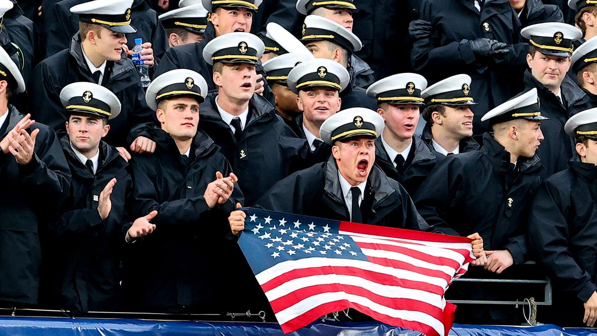 Navy Midshipmen in the stands with an American Flag during the 122nd Army/Navy college football game between the Army Black Knights and the Navy Midshipmen on Dec. 11, 2021 at MetLife Stadium in East Rutherford, New Jersey.  
