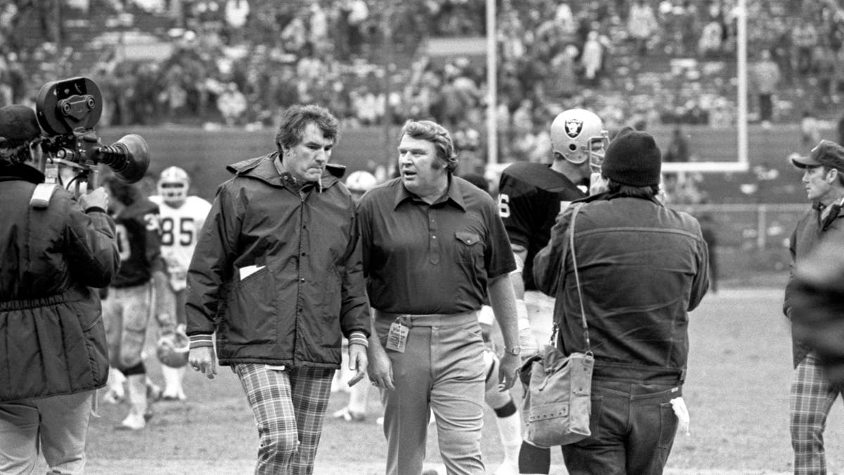 Head coaches Forrest Gregg of the Cleveland Browns (L) and John Madden of the Oakland Raiders walk off the field after a game at Cleveland Municipal Stadium on October 09, 1977 in Cleveland, Ohio. Oakland won 26-10.