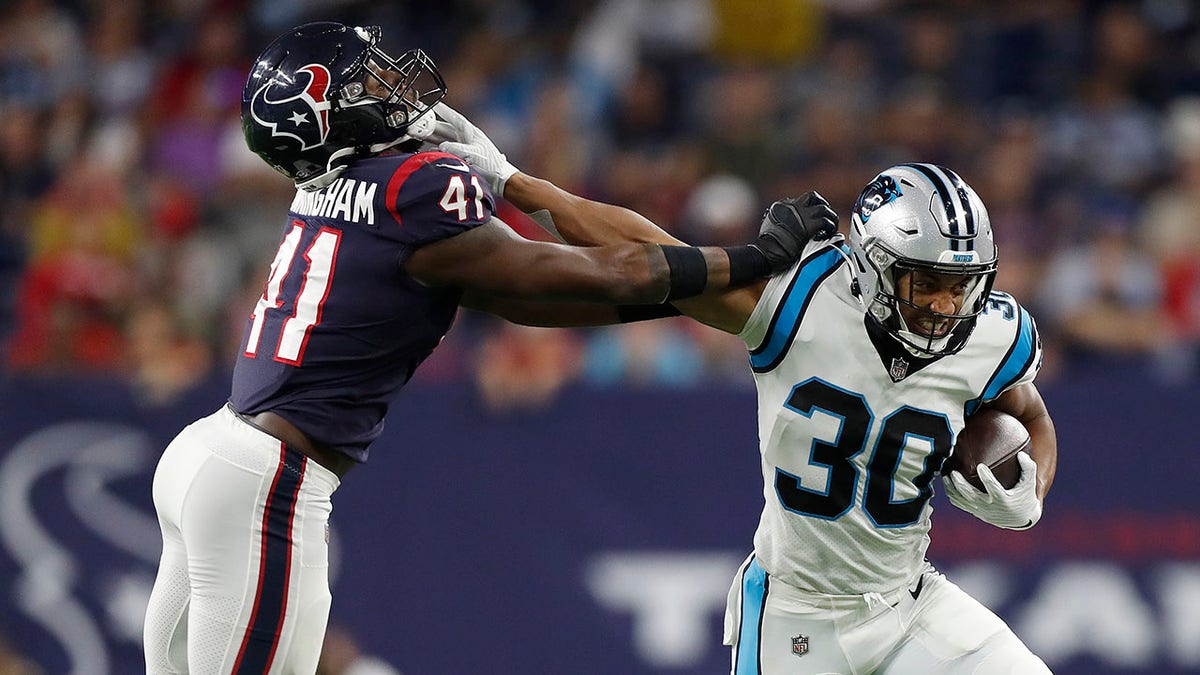 Chuba Hubbard (30) of the Carolina Panthers tries to hold off the tackle of Zach Cunningham (41) of the Houston Texans during a first half run at NRG Stadium on September 23, 2021 in Houston, Texas.