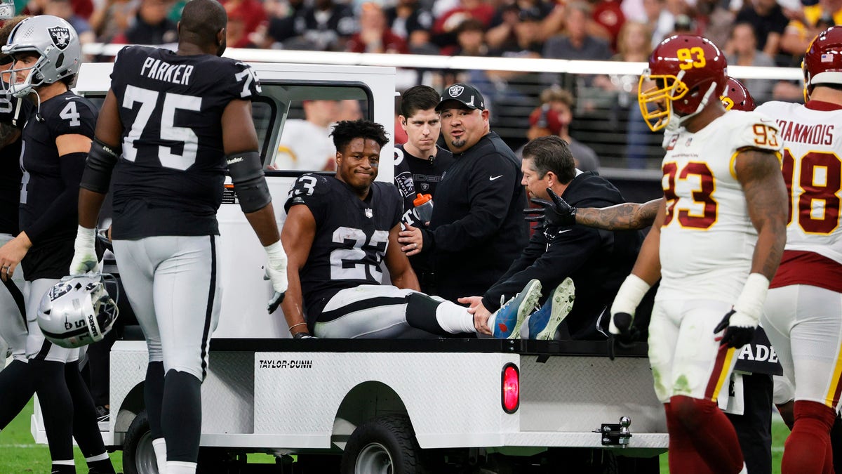 Running back Kenyan Drake of the Raiders is taken off the field on a cart after he was injured on a play against the Washington Football Team during on Dec. 5, 2021, in Las Vegas, Nevada.