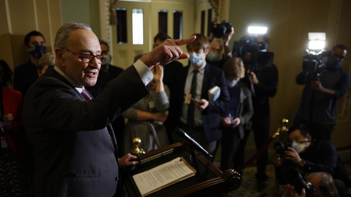Senate Majority Leader Charles Schumer talks to reporters at the U.S. Capitol on Dec. 14, 2021.