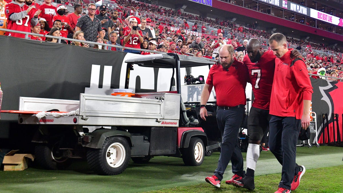 Leonard Fournette #7 of the Tampa Bay Buccaneers is helped off the field after an injury during the quarter of the game against the New Orleans Saints at Raymond James Stadium on Dec. 19, 2021 in Tampa, Florida. 