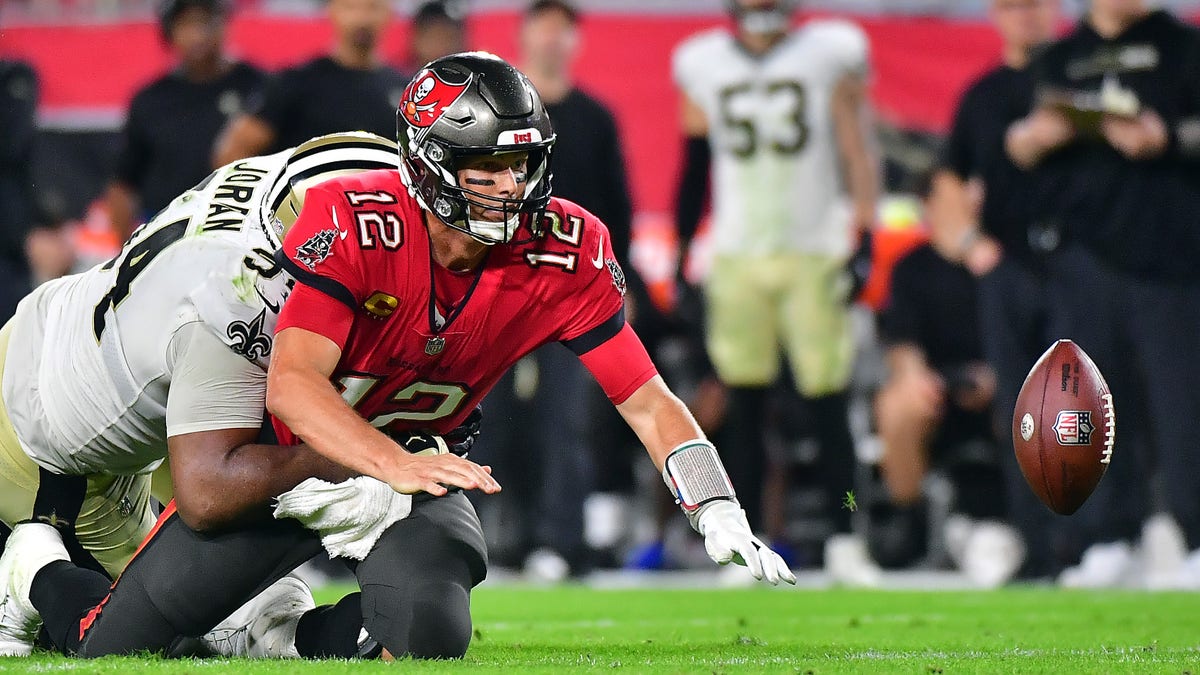 Tom Brady (12) of the Tampa Bay Buccaneers fumbles the ball as he is hit by Cameron Jordan (94) of the New Orleans Saints during the fourth quarter of the game at Raymond James Stadium on Dec. 19, 2021, in Tampa, Florida. 