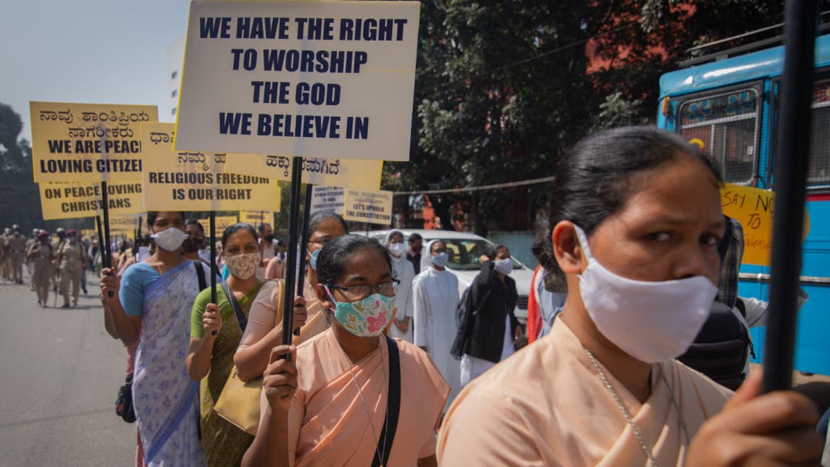 Christian nuns wave placards as they march during a demonstration against the tabling of the Protection of Right to Freedom of Religion Bill on Dec. 22, 2021, in Bengaluru, India. (Abhishek Chinnappa/Getty Images)