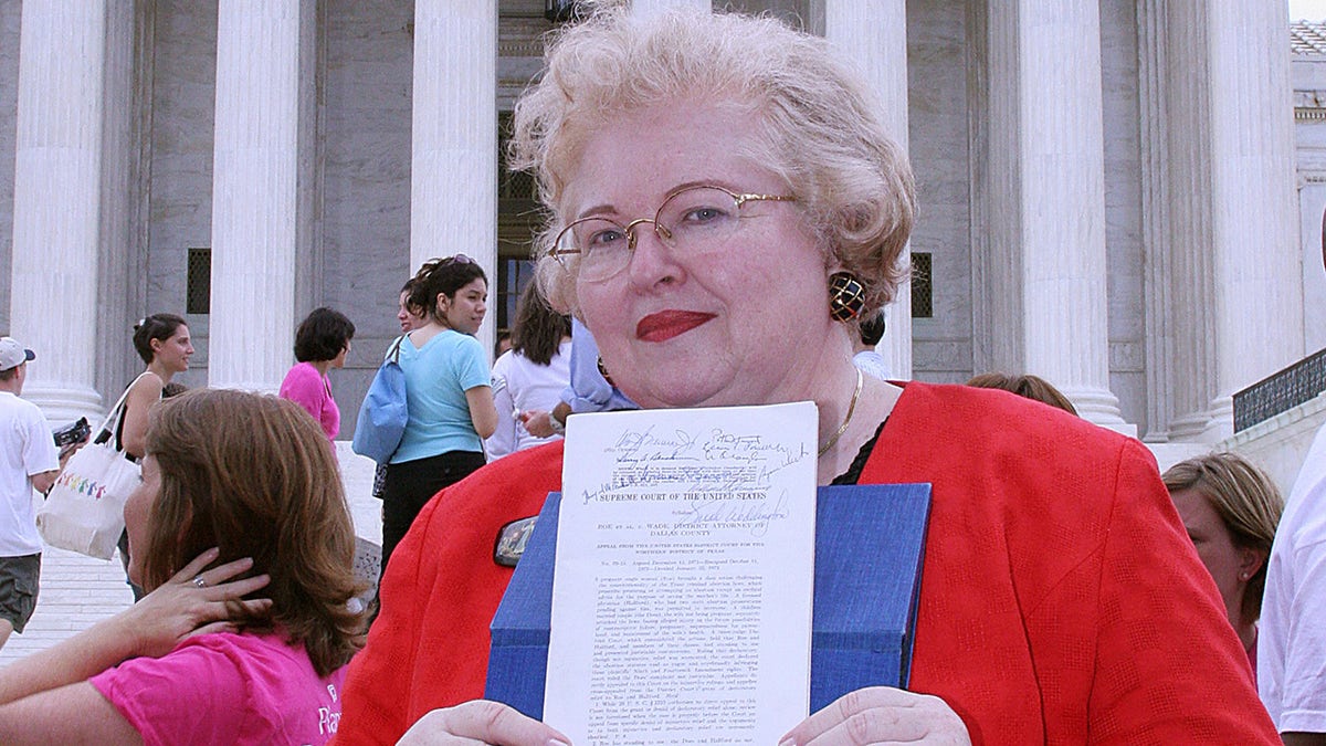 Sarah Weddington, an attorney who argued the winning side of the landmark case Roe v. Wade, to make abortion legal, before the United States Supreme Cour, poses with a signed copy of the decision in front of the US Supreme Court 27 June, 2005.