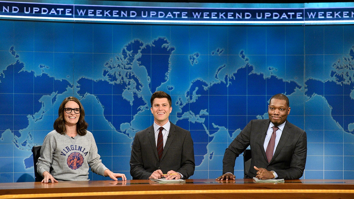 Tina Fey, Colin Jost and Michael Che sit at the "Weekend Update" desk on "Saturday Night Live," Aug. 17, 2017.