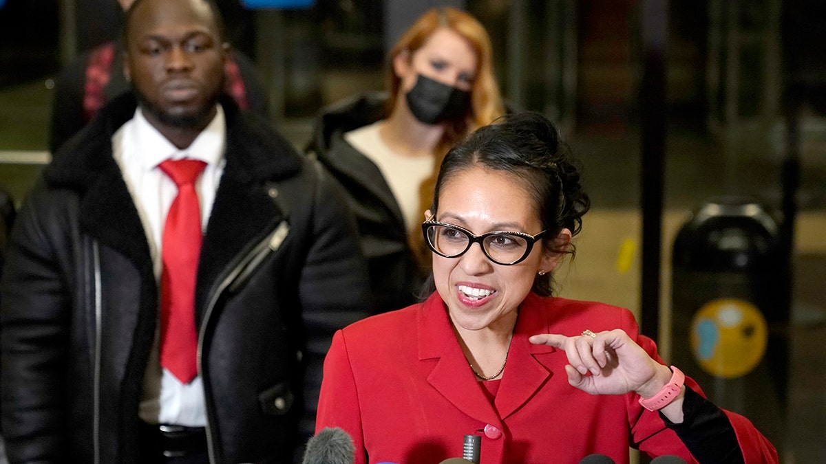 Attorney Gloria Schmidt Rodriguez, center, representing Ola Osundairo, left, talks to reporters in the Leighton Criminal Courthouse lobby Thursday, Dec. 9, 2021, in Chicago, after a jury found actor Jussie Smollett guilty on five of six charges he staged a racist, anti-gay attack on himself and lied to police about it.