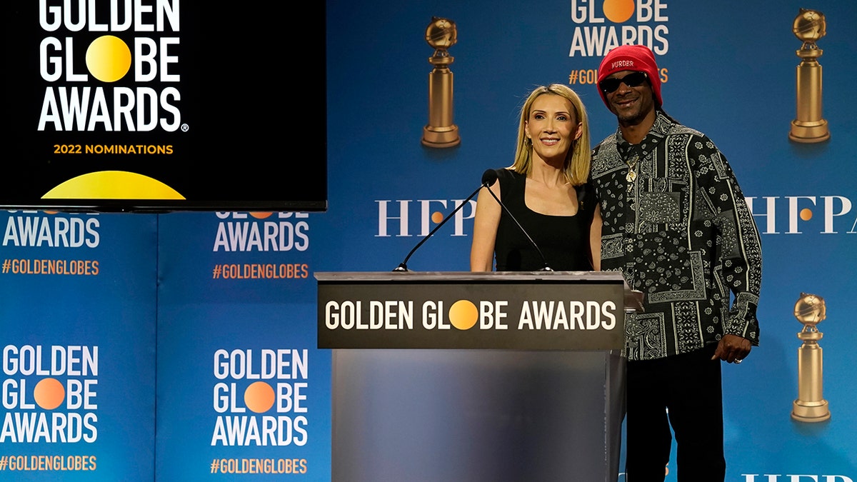 Helen Hoehne, president of the Hollywood Foreign Press Association, left, and Snoop Dogg, pose following the nominations event for 79th annual Golden Globe Awards at the Beverly Hilton Hotel on Monday, Dec. 13, 2021, in Beverly Hills, Calif. The 79th annual Golden Globe Awards will be held on Sunday, Jan. 9, 2022. 