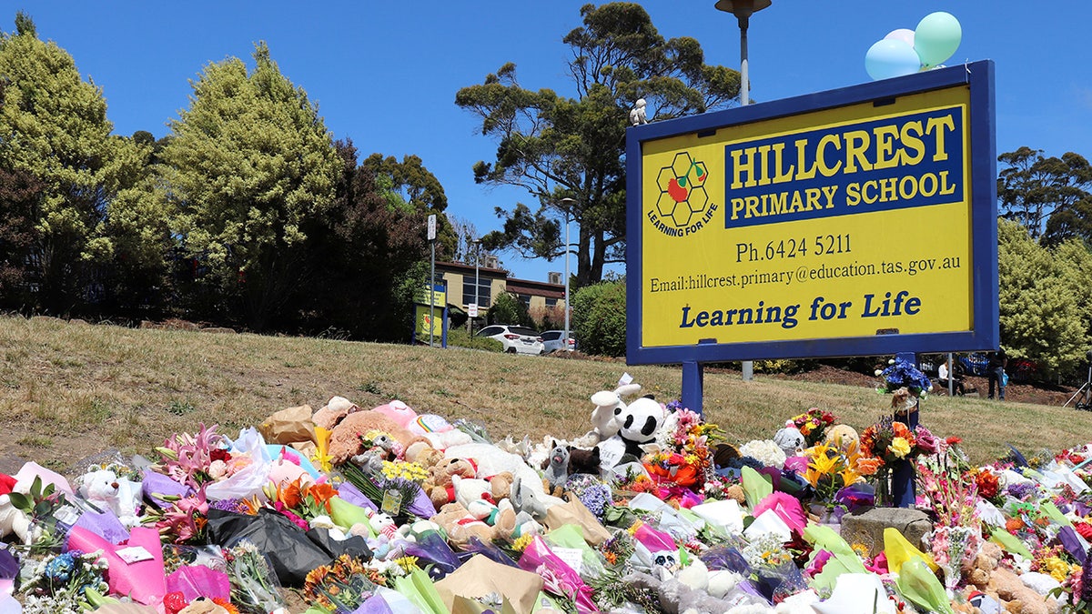 Flowers and tributes are seen outside Hillcrest Primary School in Devonport, Tasmania, Australia December 17, 2021. Australian police on Friday said investigations were continuing into the deaths of five children after a jumping castle was lifted into the air from strong winds at the school’s end-of-year celebration, including if it was properly tied to the ground. AAP Image/Ethan James via REUTERS  ATTENTION EDITORS - THIS IMAGE WAS PROVIDED BY A THIRD PARTY. NO RESALES. NO ARCHIVE. AUSTRALIA OUT. NEW ZEALAND OUT