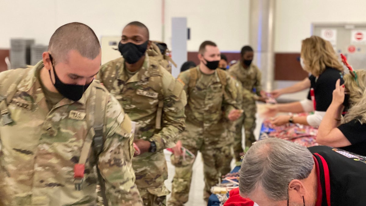 Soldiers heading home for the holidays are greeted at the Atlanta airport with goodies before they board their planes. 