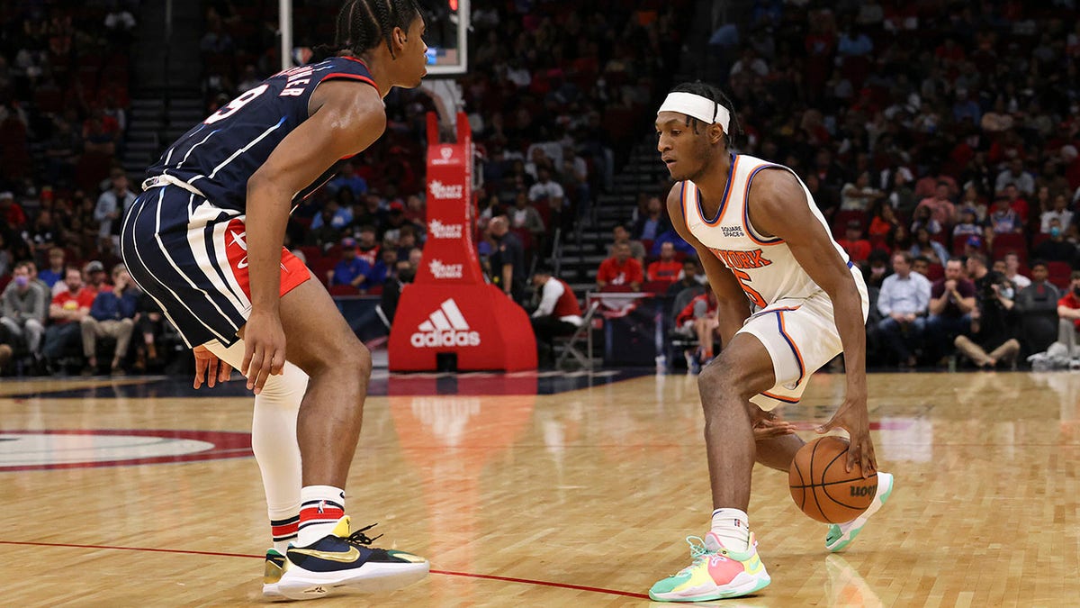 Dec 16, 2021; Houston, Texas, USA;  New York Knicks guard Immanuel Quickley (5) dribbles against Houston Rockets guard Josh Christopher (9) in the third quarter at Toyota Center.