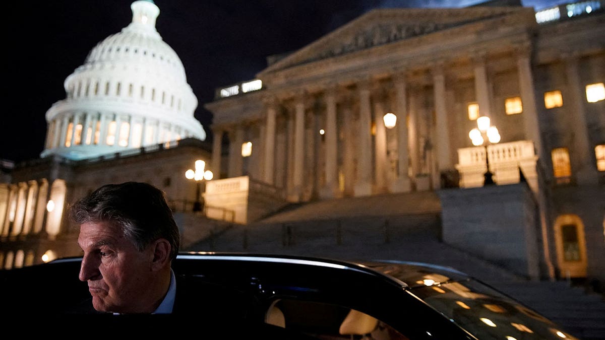 U.S. Sen. Joe Manchin, D-W.Va., gets into a car as he leaves the U.S. Capitol in Washington, D.C., Dec. 15, 2021. 