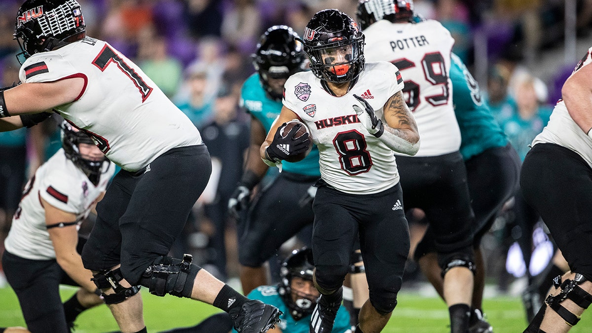 Northern Illinois running back Jay Ducker (8) runs the ball against Coastal Carolina during the Cure Bowl in Orlando, Fla., Friday, Dec. 17, 2021.