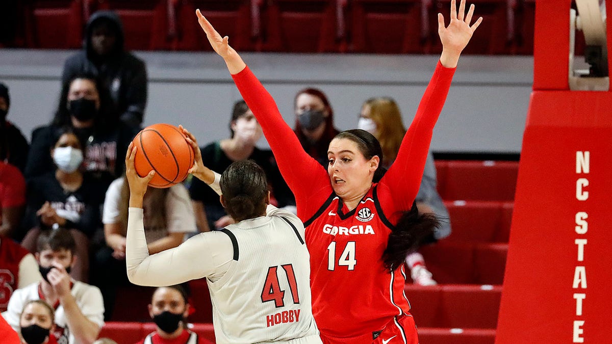 Georgia's Jenna Staiti (14) pressures North Carolina State's Camille Hobby (41) during the first half of an NCAA college basketball game, Thursday, Dec. 16, 2021, in Raleigh, N.C.