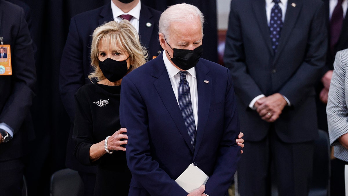 President Joe Biden stands with first lady Jill Biden as they arrive for a congressional ceremony to honor former Sen. Bob Dole, at the U.S. Capitol Rotunda in Washington, Thursday, Dec. 9, 2021. (Jonathan Ernst/Pool via AP)
