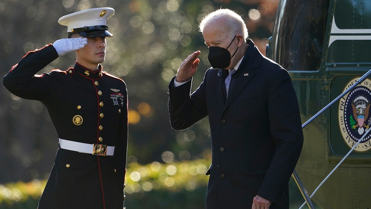 President Biden salutes as he steps off Marine One on the South Lawn of the White House in Washington, Monday, Dec. 20, 2021.