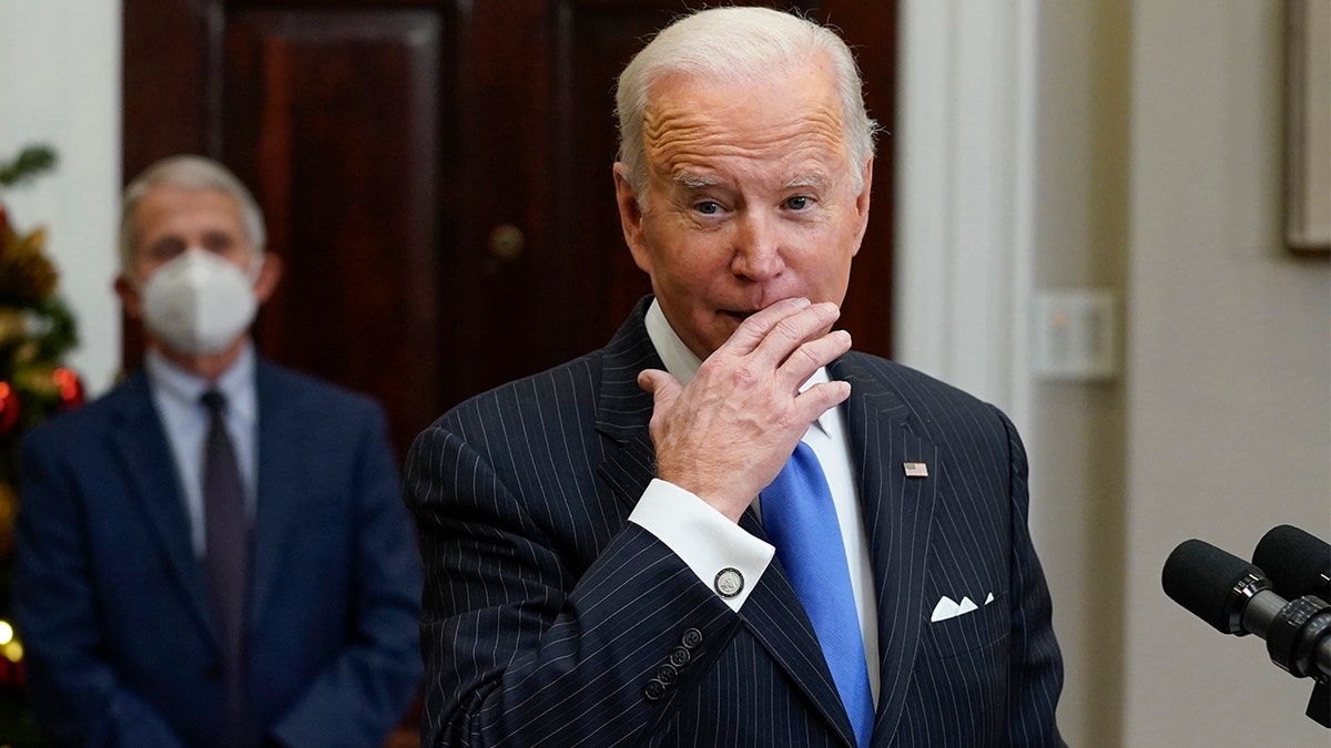 President Biden speaks about the COVID-19 variant named omicron, in the Roosevelt Room of the White House, Monday, Nov. 29, 2021, in Washington. as Dr. Anthony Fauci, director of the National Institute of Allergy and Infectious Diseases listens. (AP Photo/Evan Vucci)