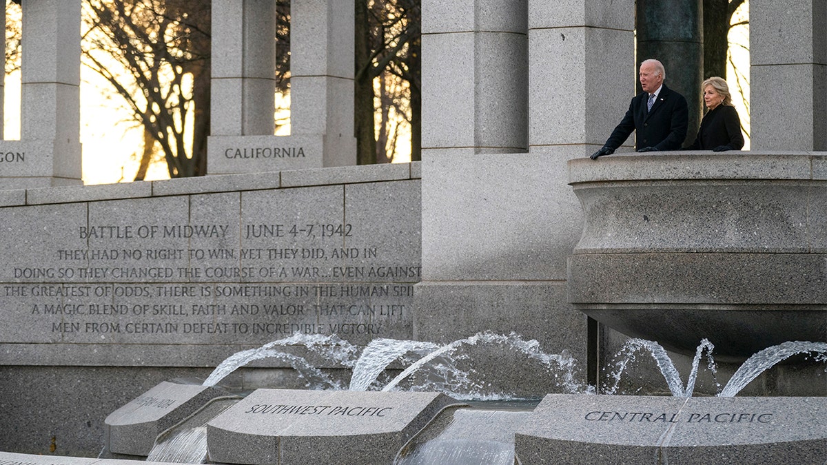 President Biden and first lady Jill Biden visit the National World War II Memorial to mark the 80th anniversary of the Japanese attack on Pearl Harbor, Tuesday, Dec. 7, 2021, in Washington.