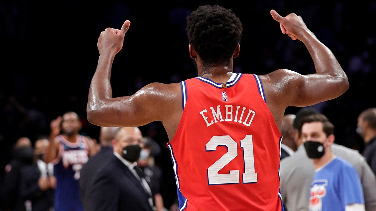 Philadelphia 76ers center Joel Embiid gestures toward Brooklyn Nets forward Kevin Durant after the two exchanged words in the final minute of the second half of an NBA basketball game Thursday, Dec. 30, 2021, in New York. 